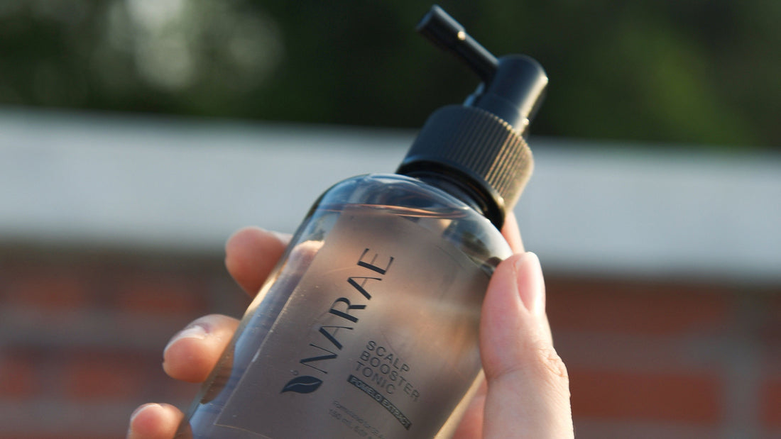 Bottle of hair tonic being applied to the scalp, demonstrating how to use hair tonic for promoting hair growth and reducing hair fall.