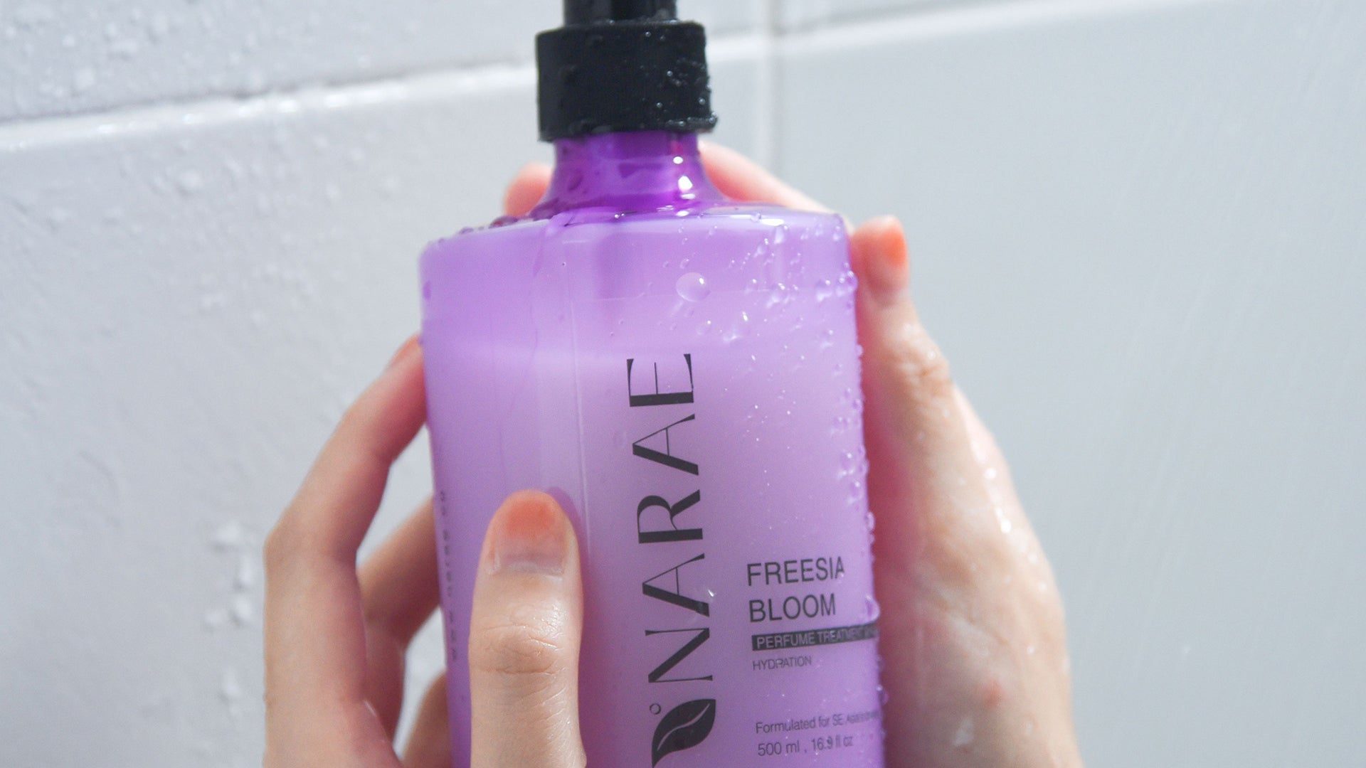 Freesia Bloom Perfumed Shampoo bottle with aloe vera and basil leaf extract, designed to repair dry, frizzy hair and leave a long-lasting floral fragrance.